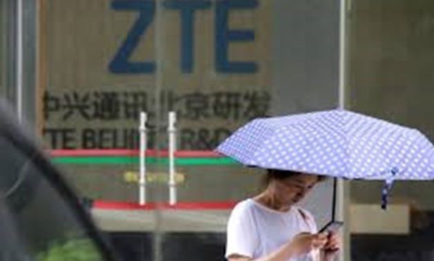 FILE PHOTO: A woman stands outside a building of ZTE Beijing research and development center in Beijing, China June 13, 2018. REUTERS/Jason Lee
