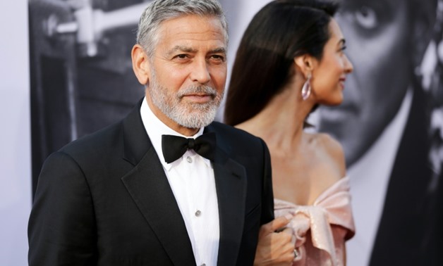 George Clooney (L) and his wife Amal -- shown here at the American Film Institute's 46th Life Achievement Award Gala Tribute to George Clooney on June 7 -- have donated $100,000 to the Young Center for Immigrant Children's Rights-GETTY IMAGES NORTH AMERIC