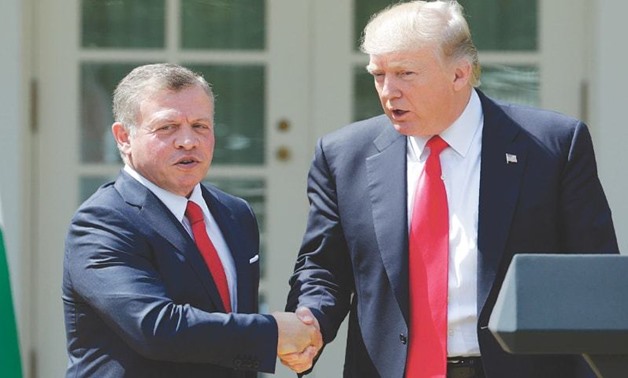 President Donald Trump and Jordan's King Abdullah shake hands at the conclusion of their joint news conference on 6 April 2017 - Reuters