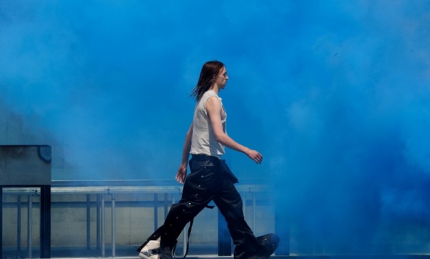 Estonian rapper Tommy Cash on the catwalk for an outdoor fashion show in Paris by Rick Owens.
