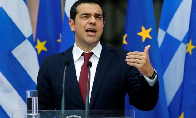 Greece's Alexis Tsipras wearing a tie for the first time since he became prime minister in 2015, after pledging we would only don one once Greece was out of debt
