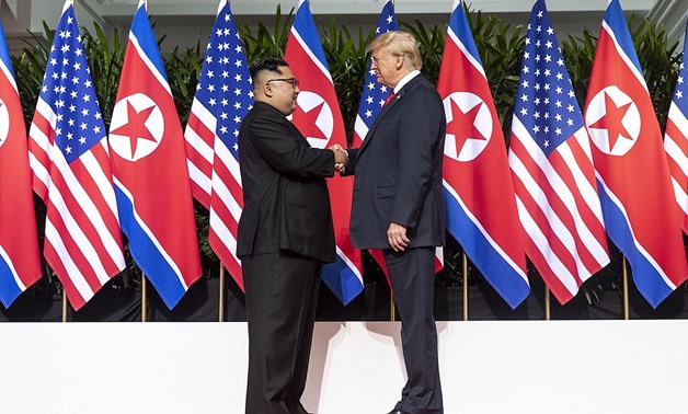 Wikipedia Commons - Kim (L) and Trump (R) shaking hands at the red carpet during the DPRK–USA Singapore Summit