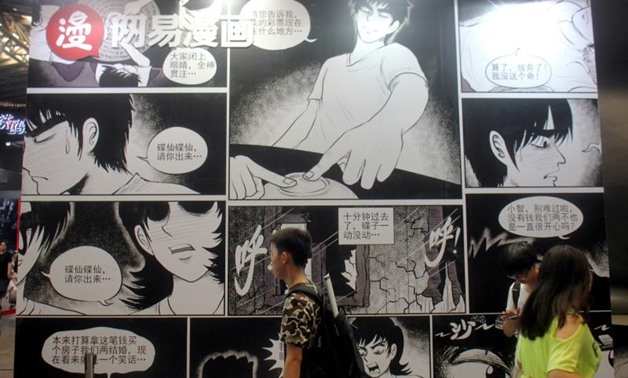 People walk past a booth of NetEase Comics at the China International Cartoon and Game (CCG) Expo in Shanghai, China July 6, 2017. REUTERS/Stringer

