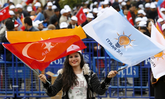 A supporter of the ruling AK Party waves national and party flags during an election rally in Ankara, Turkey, October 31, 2015. (Reuters)
