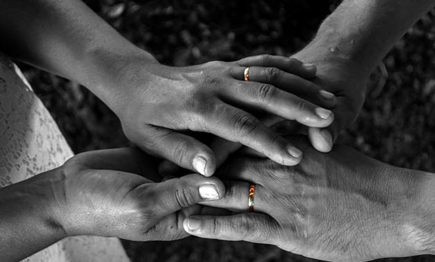 FILE - Man and woman wearing wedding rings – Pixabay/Filipe Augusto