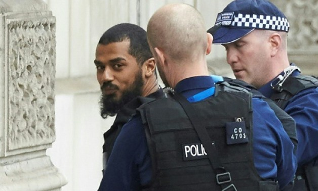 British police detaining Khalid Mohammed Omar Ali near the Houses of Parliament in central London last year. He was found guilty Tuesday of plotting a knife attack on MPs and police
