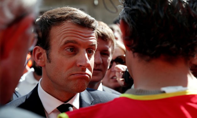 Emmanuel Macron, head of the political movement En Marche !, or Onwards !, and candidate for the 2017 presidential election, reacts while listening to a labour union employee as he arrives at the Verrerie Ouvriere in Albi, France, May 4, 2017. REUTERS/Ben