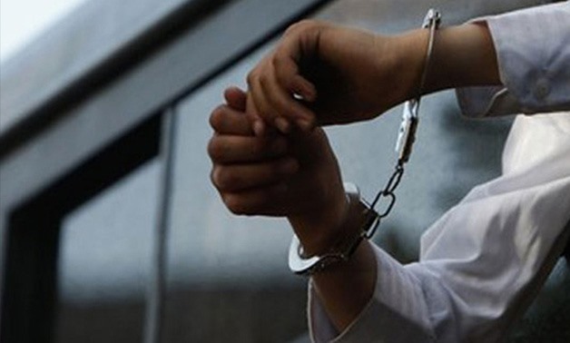 A defendant handcuffed- Reuters