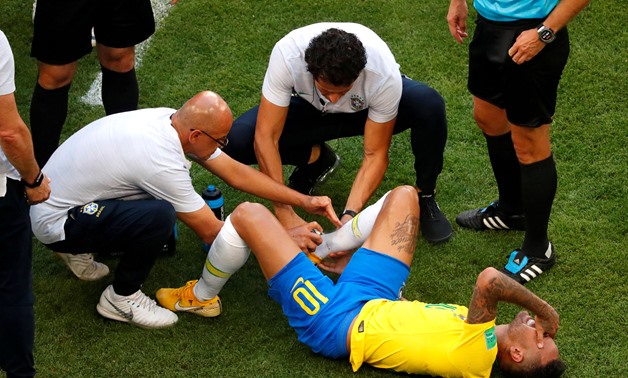FILE PHOTO: Soccer Football - World Cup - Round of 16 - Brazil vs Mexico - Samara Arena, Samara, Russia - July 2, 2018 Brazil's Neymar receives treatment from medical staff after sustaining an injury REUTERS/David Gray/File Photo
