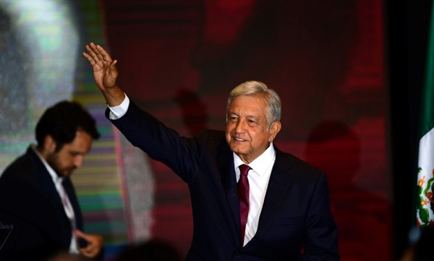 Newly elected Mexico's President Andres Manuel Lopez Obrador, running for "Juntos haremos historia" party cheers his supporters at a hotel after winning general elections, in Mexico City, on July 1, 2018
