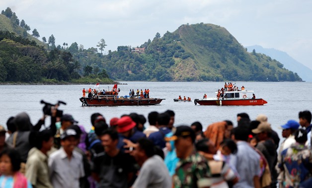 Rescue team members during an operation, as relatives of the missing passengers after a ferry sank earlier this week in Lake Toba, are waiting at Tigaras port in Simalungun, North Sumatra, Indonesia, June 22, 2018. REUTERS/Beawiharta