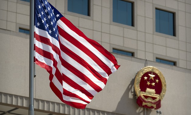 The American flag flies near the national emblem of China outside of the Bayi Building before a welcome ceremony for U.S. Defense Secretary Jim Mattis in Beijing, Wednesday, June 27, 2018 Mark Schiefelbein/Pool via Reuters