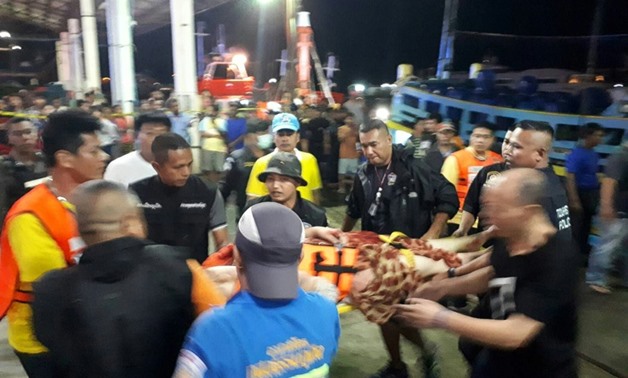 Thai paramedics attend to rescued passengers after the boat went down off Phuket
