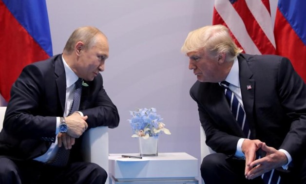 FILE PHOTO: Russia's President Vladimir Putin talks to U.S. President Donald Trump during their bilateral meeting at the G20 summit in Hamburg, Germany, July 7, 2017. REUTERS/Carlos Barria//File Photo
