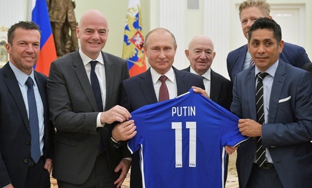 Russia's President Vladimir Putin (C) poses for a picture with (L-R) former player of team Germany Lothar Matthaeus, FIFA President Gianni Infantino, First Vice President of the Russian Football Union Nikita Simonyan, former player of team Denmark Peter S