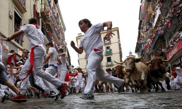 Runners sprint in front of wild cows during the first running of the bulls of the San Fermin festival in Pamplona, Spain, July 7, 2018. REUTERS/Susana Vera TPX IMAGES OF THE DAY
