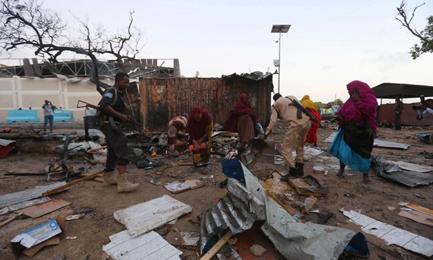 Somali women and security forces search through the damage caused at the scene of a blast near the Mogadishu sea port in Mogadishu, Somalia, May 24, 2017.
