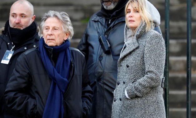 FILE PHOTO: Film director Roman Polanski and Emmanuelle Seigner arrive at the Madeleine Church to attend a ceremony during a 'popular tribute' to late French singer and actor Johnny Hallyday in Paris, France, December 9, 2017. REUTERS/Charles Platiau
