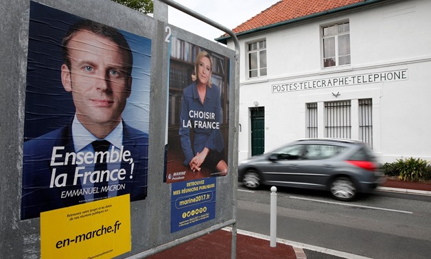 Posters of the candidates for the 2017 French presidential election - Reuters