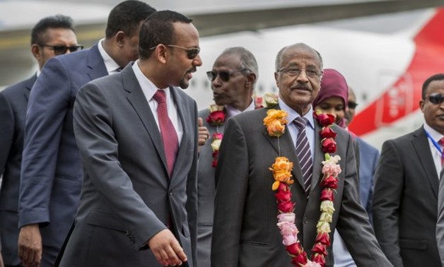 Ethiopia's Prime Minister Abiy Ahmed welcomes Eritrean Foreign Minister Osman Saleh and his delegation at the Bole International Airport in Addis Ababa, Ethiopia June 26, 2018 - Reuters