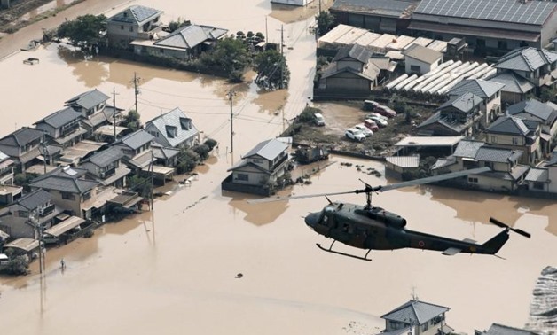 A helicopter flies over Mabi town which was flooded by the heavy rain in Kurashiki, Okayama Prefecture, Japan, in this photo taken by Kyodo July 9, 2018. Mandatory credit Kyodo/via Reuters