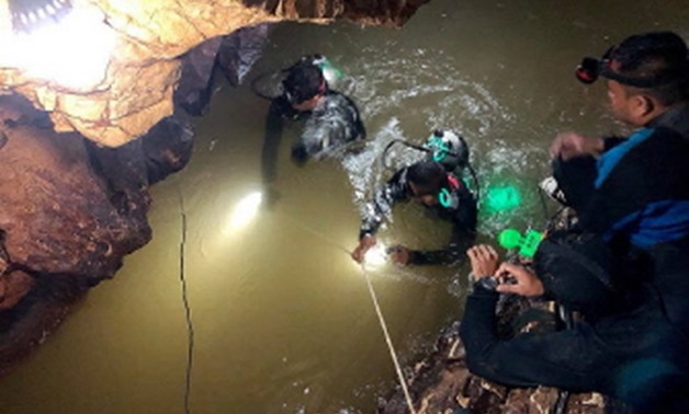 Chiang Rai, Thailand : This handout photo taken on June 28, 2018 and released by the Royal Thai Navy SEAL on June 29, 2018 shows a team of Royal Thai Navy SEAL divers inspecting the water-filled tunnel in the Tham Luang cave during a rescue operation for 