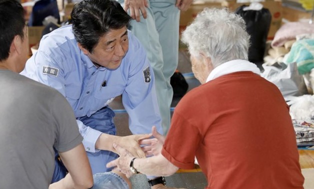 Japan's Prime Minister Shinzo Abe meets local residents staying at an evacuation center in Kurashiki, Okayama Prefecture, Japan - Reuters