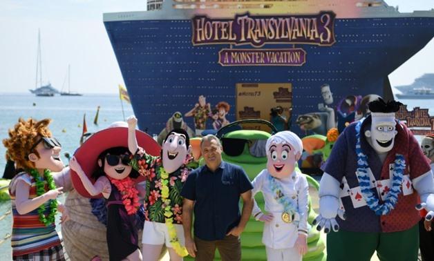 Russian-US director Genndy Tartakovsky (C) poses on May 7, 2018 during a photocall for the animated film "Hotel Transylvania 3 : A Monster Vacation"-AFP / LOIC VENANCE

