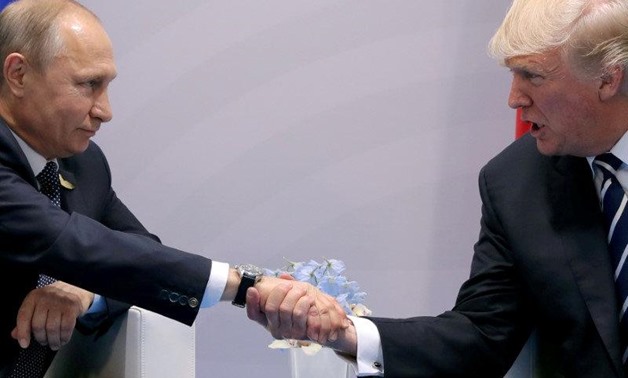 FILE PHOTO: FILE PHOTO: U.S. President Donald Trump shakes hands with Russian President Vladimir Putin during the their bilateral meeting at the G20 summit in Hamburg, Germany, July 7, 2017. REUTERS/Carlos Barria/File Photo/File Photo