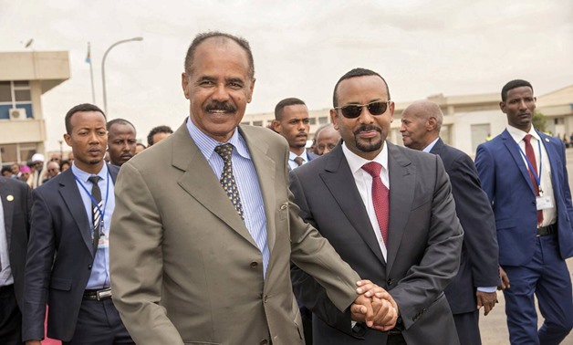 Eritrean President Isaias Afwerki and Ethiopia's Prime Minister Abiy Ahmed and walk together at Asmara International Airport, Eritrea July 9, 2018 in this photo obtained from social media on July 10, 2018. GHIDEON MUSA ARON VISAFRIC/via REUTERS