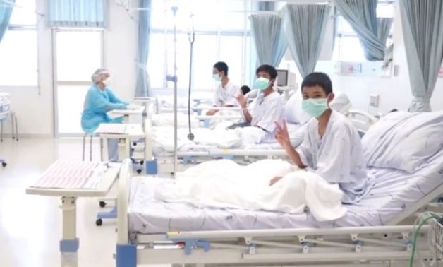 A screen grab shows boys rescued from the Thai cave wearing mask and resting in a hospital in Chiang Rai, Thailand from a July 11, 2018 handout video. Government Public Relations Department (PRD) and Government Spokesman Bureau/Handout via REUTERS TV
