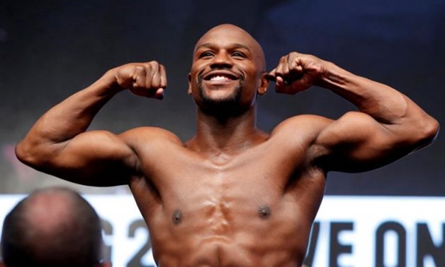 FILE PHOTO: Boxer Floyd Mayweather Jr. of the U.S. poses in the scale during his official weigh-in at T-Mobile Arena in Las Vegas, Nevada, U.S. on August 25, 2017. REUTERS/Steve Marcus/File Photo.