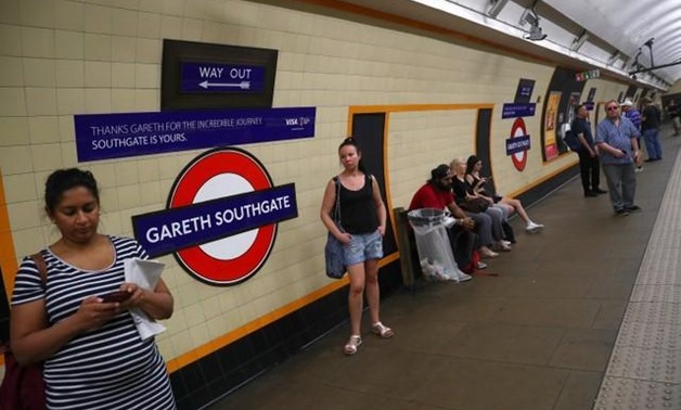 Passengers wait at Southgate Underground Station, temporarily renamed as 'Gareth Southgate' in honour of England soccer team manager Gareth Southgate, in London, Britain July 16, 2018. REUTERS/Hannah McKay
