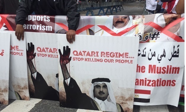 Anti-Qatar banners in protests outside the UN HQ in NY on Sept. 19, 2017 - Egypt Today