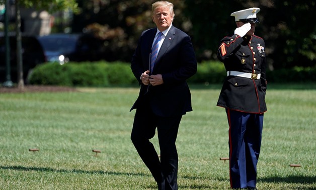 U.S. President Donald Trump walks from Marine One as he arrives on the South Lawn of the White House in Washington, U.S., July 18, 2018. REUTERS/Joshua Roberts