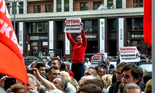 A man holds a poster reading "Putin! How to survive to retirement?" during a rally against plans to increase the Russian retirement age for both men and women
