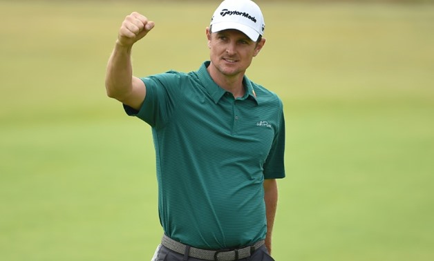 Justin Rose reacts after holing his birdie putt on the 18th green for a third round of 64 on day 3 at Carnoustie
AFP / Paul ELLIS
