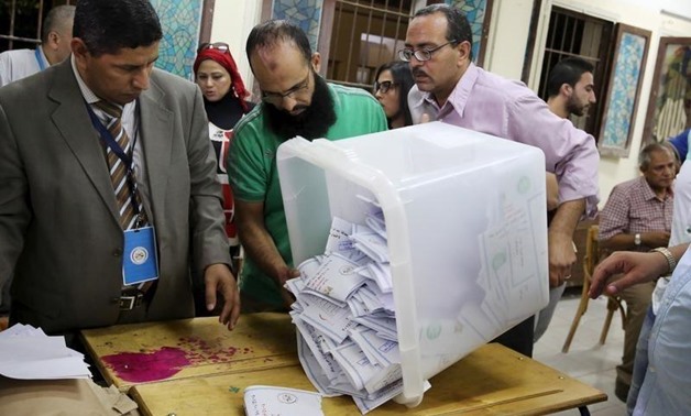 Employees count ballots after polls closed in the first phase of parliamentary elections at a voting center in Dokki, Giza governorate, Egypt, October 19, 2015 – Reuters