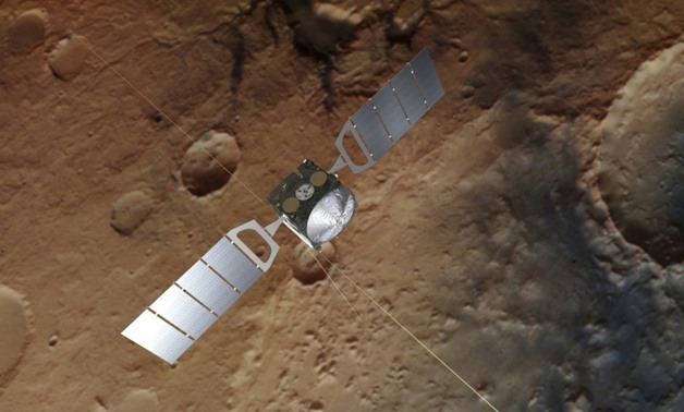 A photograph obtained from the European Space Agency on July 25, 2018, shows an artist's impression of Mars Express over a background based on an actual image of the Red Planet taken by the spacecraft
