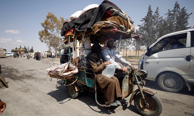Internally displaced people who fled Raqqa city ride a tricycle with their belongings as they leave a camp in Ain Issa, Raqqa Governorate, Syria May 4, 2017. Picture taken May 4, 2017. REUTERS/Rodi Said