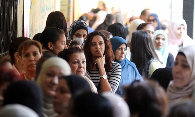 Egyptian women queue at a polling station in the capital Cairo on Nov. 22, 2015, on the first day of the second and final round of the country's parliamentary elections - AFP