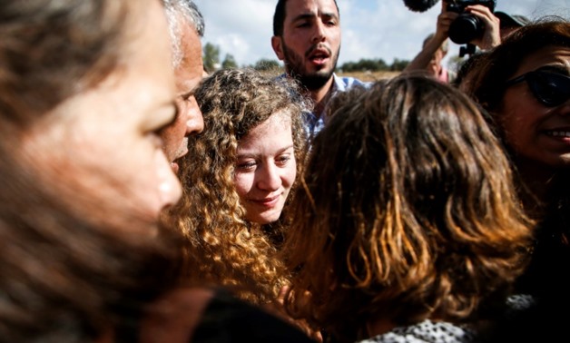 Palestinian activist and campaigner Ahed Tamimi (C) arrives in her West Bank village of Nabi Saleh on July 29, 2018 after being released from prison following an eight-month sentence for slapping two Israeli soldiers-AFP / ABBAS MOMANI

