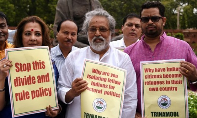 © Prakash Singh, AFP | The All India Trinamool Congress (TMC) Members of Parliament hold placards against the non-inclusion of over 4 million people in Assam's National Register of Citizens during a protest in Parliament in New Delhi on July 31, 2018.
