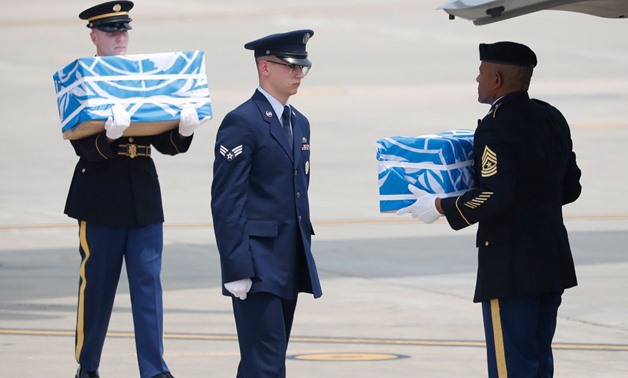 Soldiers carry caskets containing remains of US troops who were killed in the Korean War during a ceremony at Osan Air Base in Pyeongtaek on July 27, 2018.
