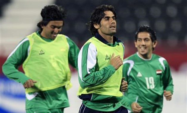 Iraq's national soccer team players Nashat Akram (L), Alaa Abdul Zahrah (C) and Ahmed Anwer take part in a training session for the Asian Cup soccer tournament at Al Rayyan Stadium in Doha January 10, 2011. REUTERS/Mohammed Dabbous

