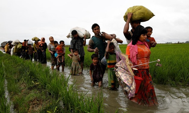A group of Rohingya refugee people walk in the water after crossing the Bangladesh-Myanmar border in Teknaf, Bangladesh, September 1, 2017. REUTERS/Mohammad Ponir Hossain