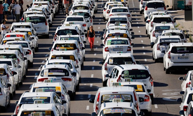 FILE- Taxis block a section of the main avenue Paseo de la Castellana during a strike against what they say is unfair competition from ride-hailing and car-sharing services such as Uber and Cabify, in Madrid, Spain, July 31, 2018. REUTERS/Paul Hanna/