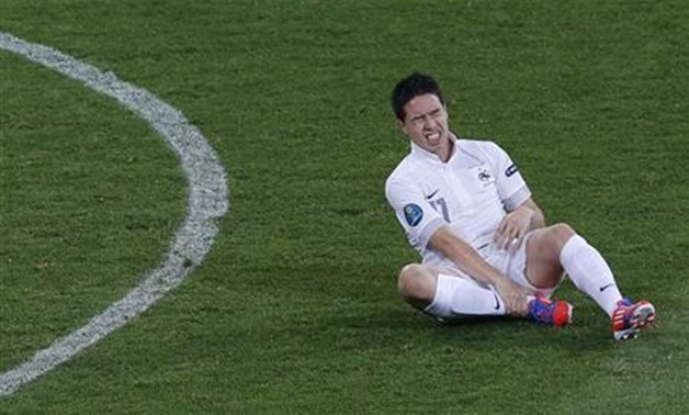 France's Samir Nasri grimasses after being fouled during their Group D Euro 2012 soccer match against Sweden at the Olympic stadium in Kiev, June 19, 2012.
