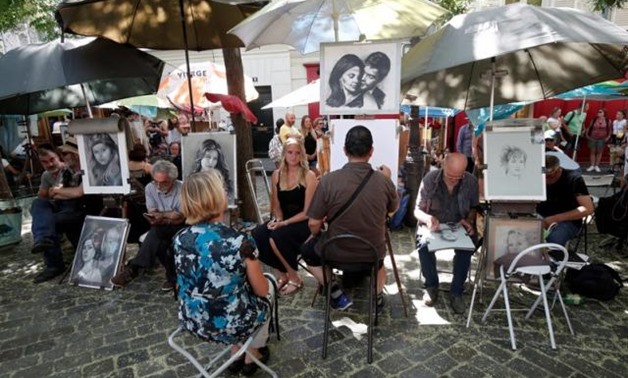 General view of artists who sketch portraits in the street on the "Place du Tertre", a square at the Butte Montmartre area in Paris, France, August 2, 2018. REUTERS/Benoit Tessier.
