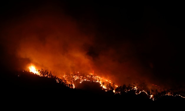 Flames of an approaching forest fire are seen near small village of Monchique, Portugal August 5, 2018. REUTERS/Rafael Marchante